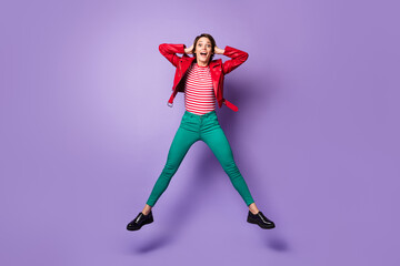 Fototapeta na wymiar Full length photo of young excited girl happy positive smile amazed shocked surprised jump isolated over violet color background
