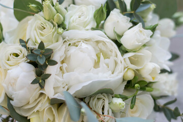 White wedding bouquet omposed od peony, roses, lisianthus, freesia and eucalyphus. Close up.