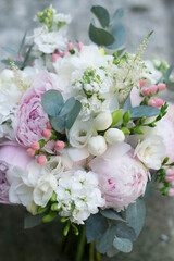 Pink wedding bouquet, composed of roses, freesias, peonies, hypericum, astilba and eucalypthus.