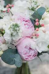 Pink wedding bouquet, composed of roses, freesias, peonies, hypericum, astilba and eucalypthus.