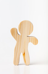 A figurine of a toy man carved from solid pine with a hand jigsaw. On a white background