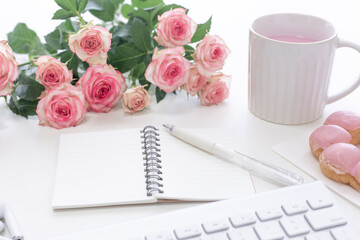 Pink concept. Rose, keyboard and drink