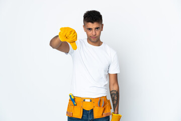 Young Brazilian electrician manipulated isolated on white background showing thumb down with negative expression