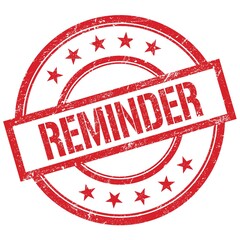 REMINDER text written on red vintage stamp.
