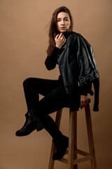 portrait of a woman with long hair sitting on a chair