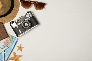 Top view photo of hat sunglasses camera map plane model starfishes and passport cover on isolated...