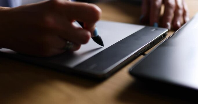 Creative female graphic designer draw on graphic table, working on creative project at home, Illustrator hands scetching on tablet computer, using stylus, Concept of modern art and technology.