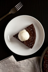 Homemade Chocolate Cake with Ice Cream on a black surface, top view. Flat lay, overhead, from above.