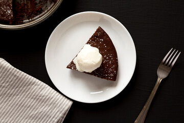 Homemade Chocolate Cake with Ice Cream on a black background, top view. Flat lay, overhead, from above.
