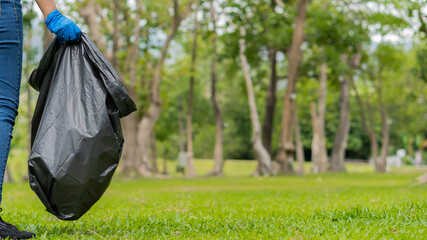 Collect garbage in the ecological group park. Concept of environmental protection. Team up with external recycling projects