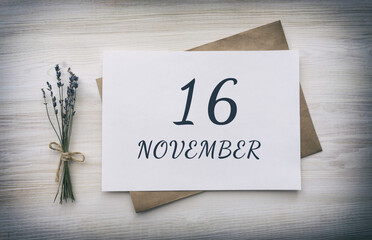 november 16. 16th day of the month, calendar date.White blank of paper with a brown envelope, dry bouquet of lavender flowers on a wooden background. Autumn month, day of the year concept