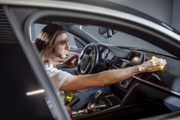 Man sitting in drivers seat of car