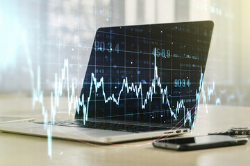 Double exposure of abstract creative financial chart on modern laptop background, research and strategy concept