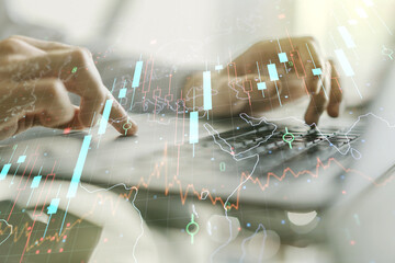 Double exposure of abstract creative financial chart with world map and with hands typing on computer keyboard on background, research and strategy concept