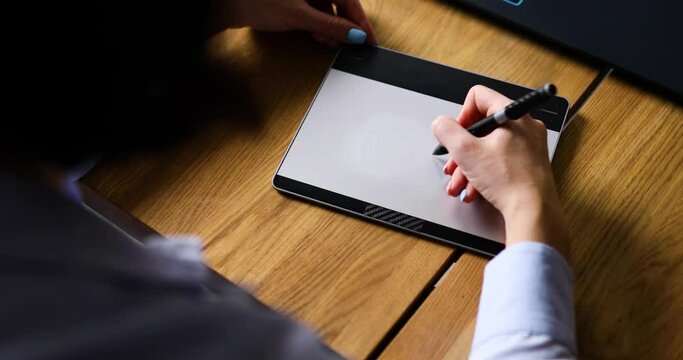 Creative female graphic designer draw on graphic table, working on creative project at home, Illustrator hands scetching on tablet computer, using stylus, Concept of modern art and technology.