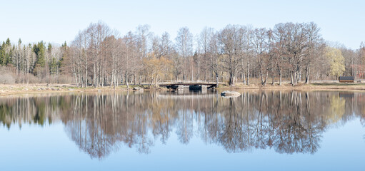 Calm lake reflection in spring. Farnebofjarden national park in north of Sweden.