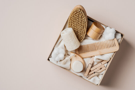 Beauty Box With Self Care Cosmetics And SPA Accessories. Flat Lay, Top View Present Box With Wooden Hair Comb, Body Brush, Loofah, Moisturizer Cream.