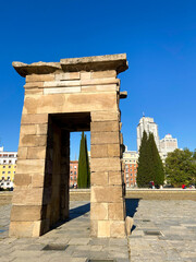 Fototapeta na wymiar View of the ancient temple of Debod with the spanish building and Madrid city at the back on a sunny day.