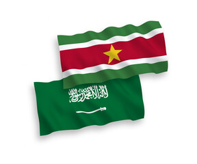 National vector fabric wave flags of Saudi Arabia and Republic of Suriname isolated on white background. 1 to 2 proportion.