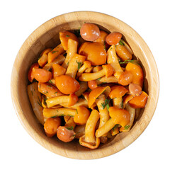 Pickled honey mushrooms in wooden bowl isolated on white. Top view.