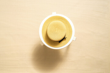 Straw hat on the white table on the sandy beach. Summer vocation. Top view © flowertiare