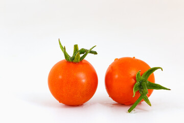 Fresh red tomatoes on a white background.