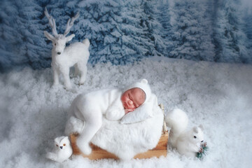 Sleeping baby boy wearing a white hat
