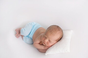 Adorable baby sleeping on his hands. first days of life. Great sleep of newborn 
