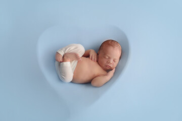 Newborn baby boy sleep on blue blanket. Cute sleeping newborn
