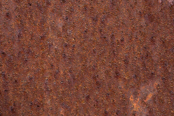 Rectangular flat background from a metal rusty sheet of red color. Rusty stains with a beautiful texture