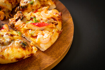 seafood pizza on wood tray