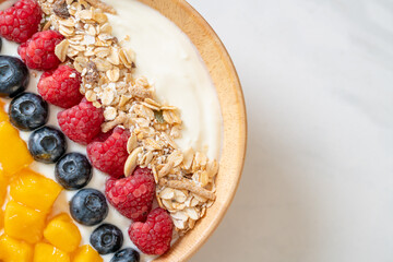 homemade yogurt bowl with raspberry, blueberry, mango and granola