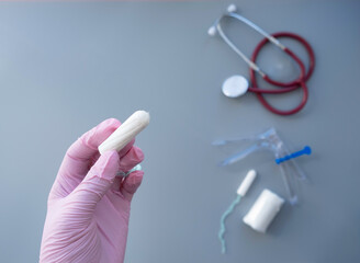 layout with medical instruments, tampons, on a gray background.