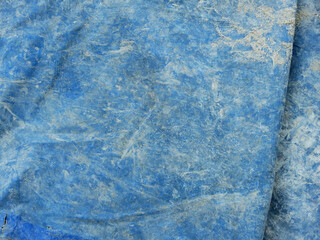 old blue plastic canvas with stain of dry cement texture