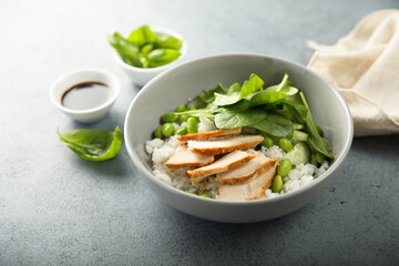 Healthy rice bowl with chicken and spinach