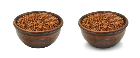 brown rice in clay bowl on white background, isolated and with shadow