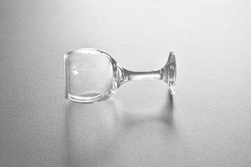 Empty glass goblet on the table. Black and white image.