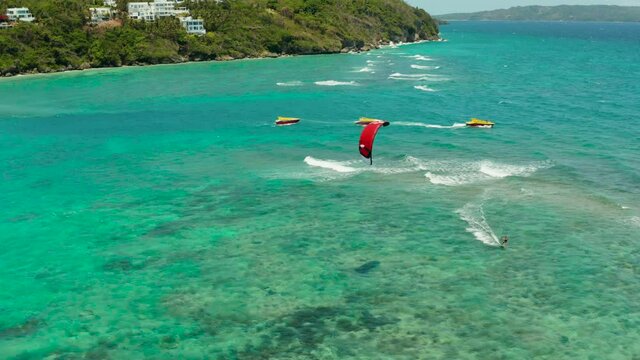 Kitesurfers enjoying wind power on Bulabog beach, top view. Kitesurfing on a tropical island. Boracay, Philippines