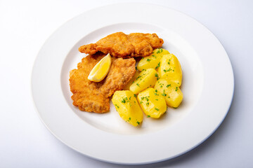 Pork chop with parsley potatoes and lemon