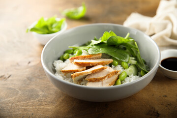 Healthy rice bowl with chicken and spinach