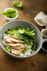Healthy rice bowl with chicken and spinach