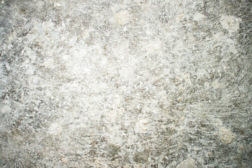 White dirty dusty plain floor surface in a renovated building covered with dust from grinding and painting the walls. White dirty monochrome background.