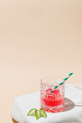 Fresh raspberry juice on a pastel orange background. Minimal summer concept.