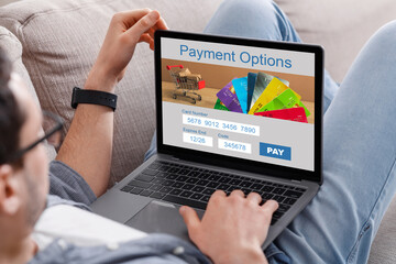 Cropped of man filling payment form on Internet, using laptop