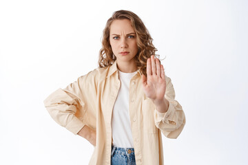 Stop, keep distance. Serious displeased woman stretch hand in block, refuse gesture, saying no,...