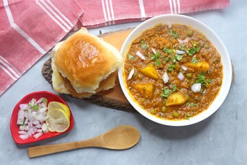 Indian famous dish Mutton Kheema Pav or Khima Paav is a minced goat meat curry. Mutton keema cooked with onion, tomatoes, potatoes, green peas along with Indian spices. copy space.