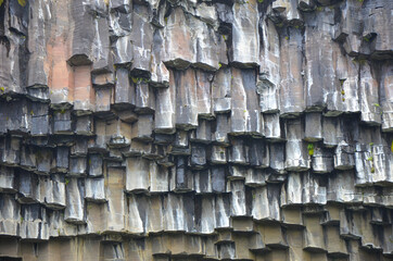 Closeup shot of basalt columns in Svartifoss, a stone background