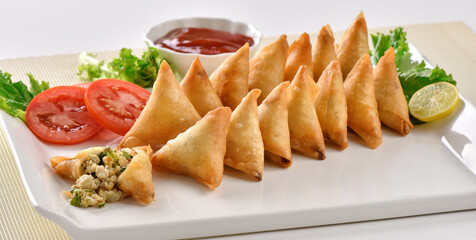 Chicken and Vegetable Samosa, Pakistan and India's most eating snack. Triangle Shape Crunchy Wraps and stuffed with vegetables and chicken.