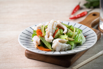 Stir-fried neritic squid with celery. Delicious homemade seafood with vegetable meal.