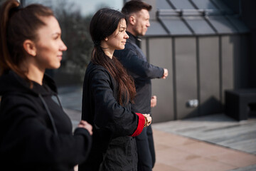 Calm martial artists standing one after another